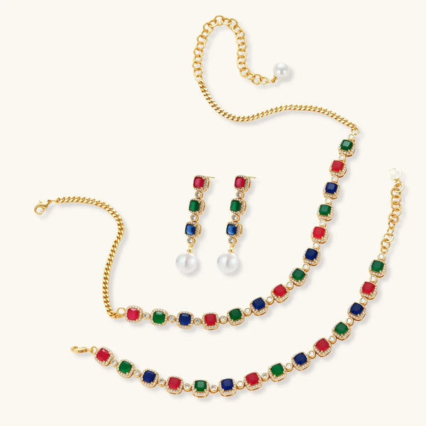 Gold-plated jewelry set with red, green, and blue cubic zirconia stones including necklace, bracelet, and drop earrings.