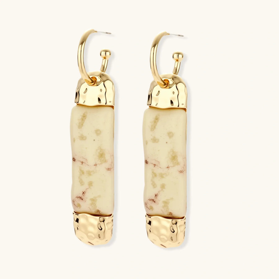 Cylindrical bar earrings featuring speckled natural resin center with polished metal caps and lever-back closures