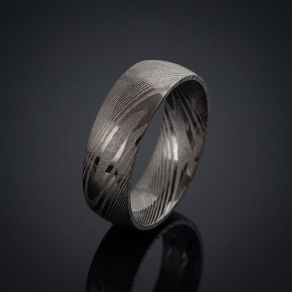 Pluto men's Damascus steel ring – angled view