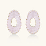 Oval lavender enamel earrings with marbled finish and gold-plated beaded border on cream background.
