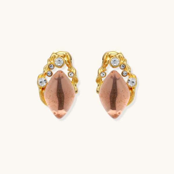 Gold-plated baroque stud earrings with coral-pink liuli stones and cubic zirconia crystals on white background.