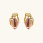 Gold-plated baroque stud earrings with coral-pink liuli stones and cubic zirconia crystals on white background.