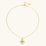 Gold-plated necklace with circular white enamel pendant featuring central zirconia stone and ornate decorative details