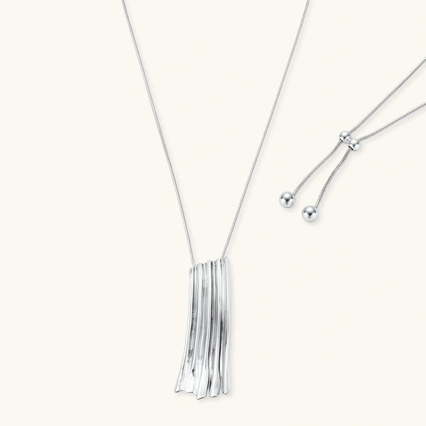 Modern silver necklace with vertical ridged pendant and adjustable chain on white background, eco-friendly zinc alloy construction.