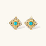 Close-up of 18K gold plated hoop earrings with turquoise center stones and zircon crystals in quatrefoil flower design