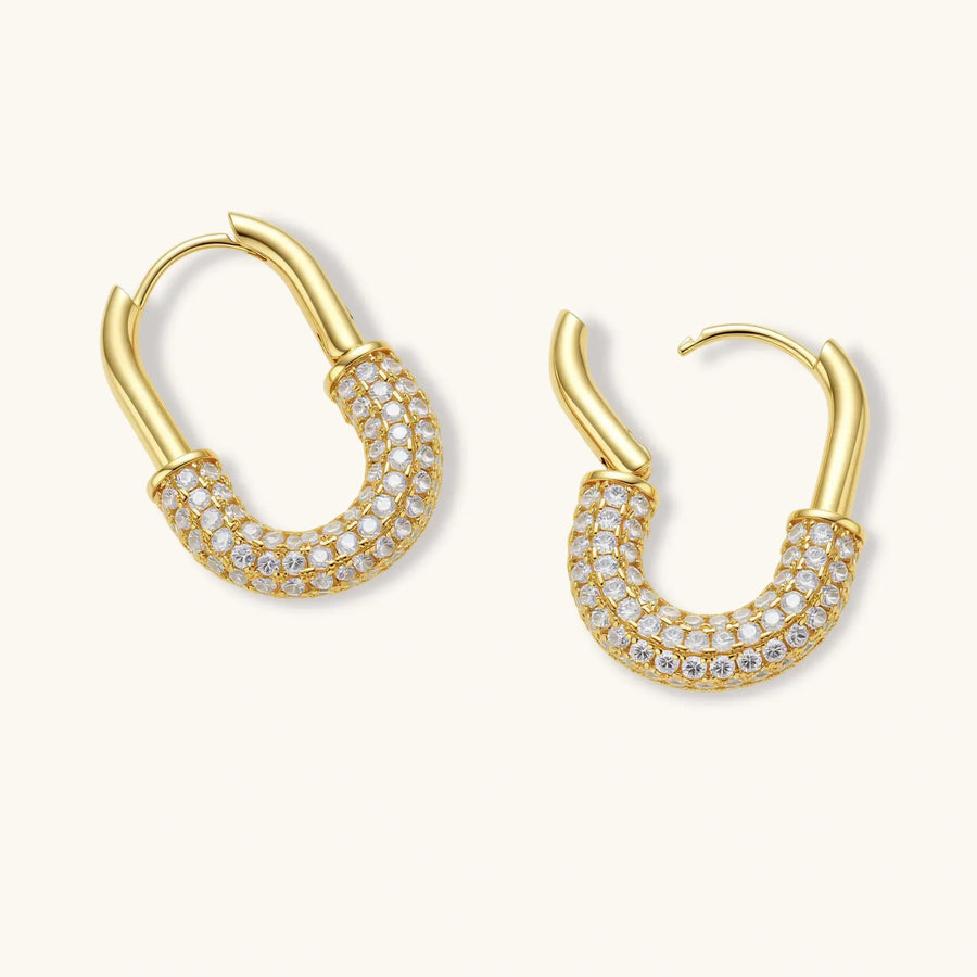 Gold-plated huggie hoop earrings with pavé zirconia stones covering the bottom curve, shown in open and closed positions.