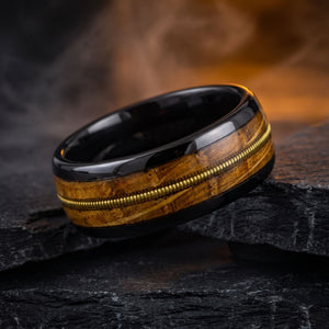 Harmonia men's black tungsten ring with whiskey barrel oak and guitar string inlay – lifestyle photo